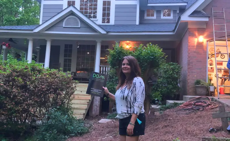 Liz from Atlanta GA giving a 5-star review for Dom Roofing & Restoration after hail damage roof and gutter replacement with excellent communication and service