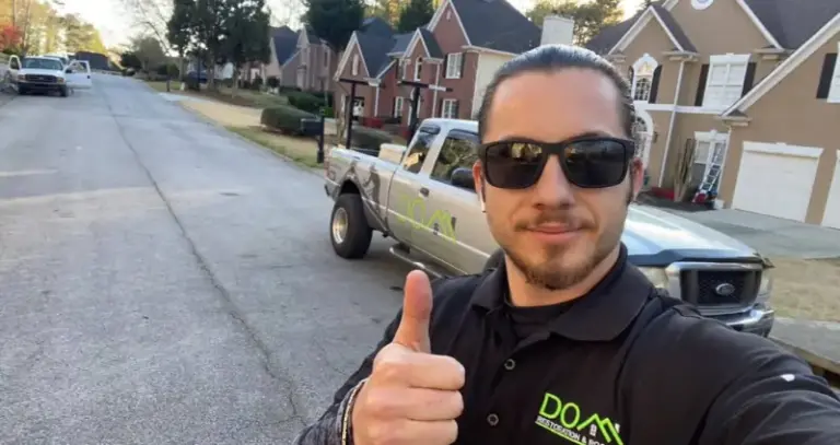 DOM Roofing inspector evaluating shingles on a Buford GA residential roof