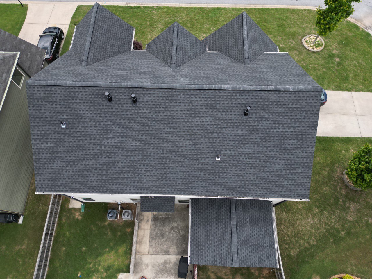 Roofing Company in Kennesaw, GA 2 Top-down aerial of a new charcoal architectural shingle roof by Dom Roofing, serving Kennesaw, GA