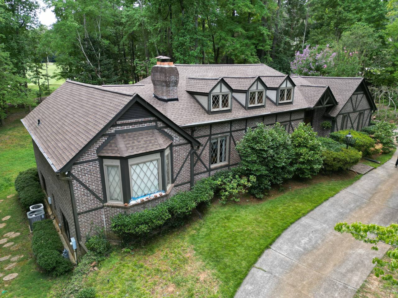 Norcross, GA Roofing | Dom Roofing & Restoration 1 New designer shingle roof on a Tudor-style brick home by Dom Roofing, serving Norcross, GA