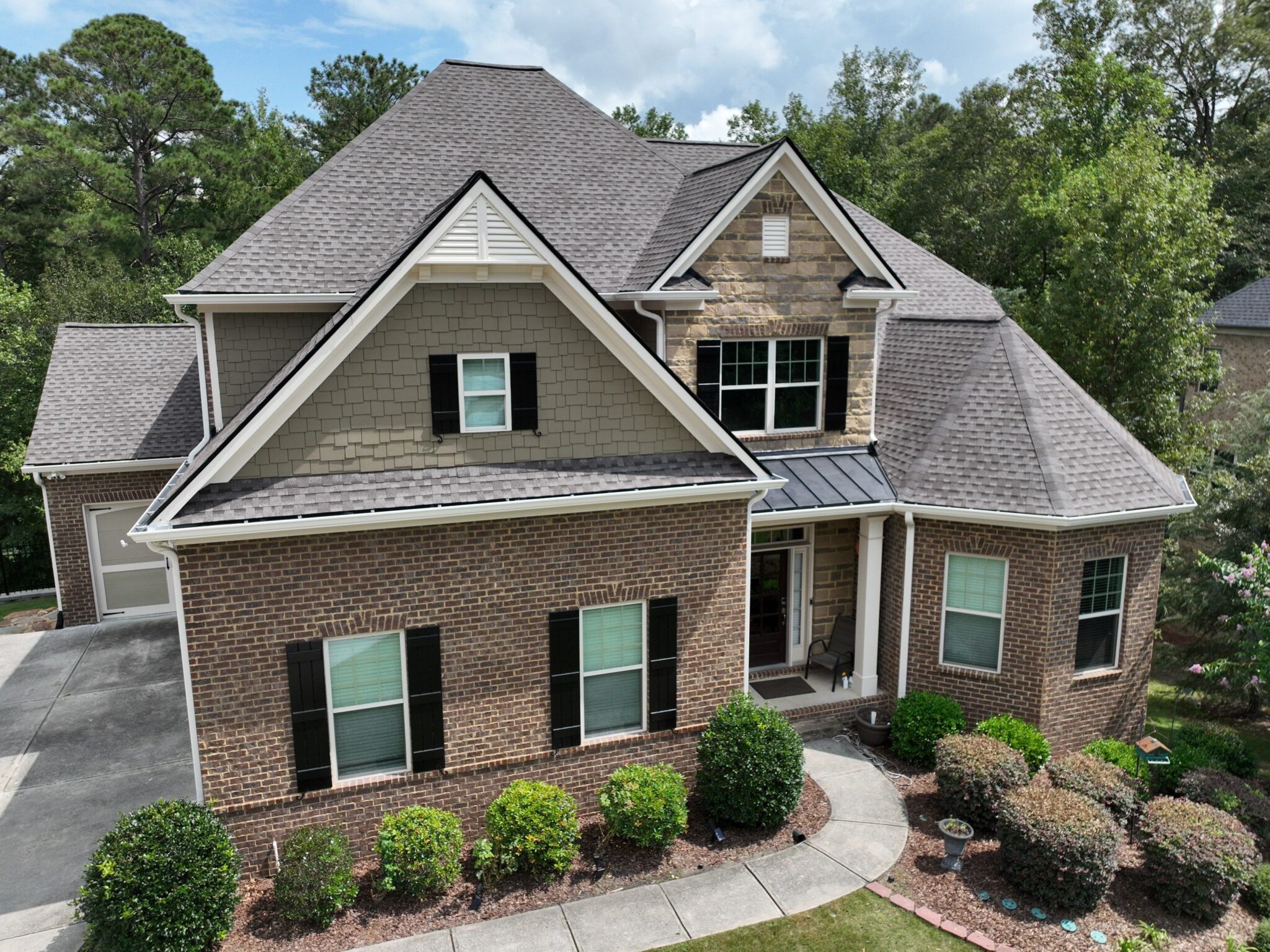 Peachtree Corners, GA Roofing | Dom Roofing & Restoration 2 Completed architectural shingle roof replacement on a brick and stone home in Peachtree Corners, GA