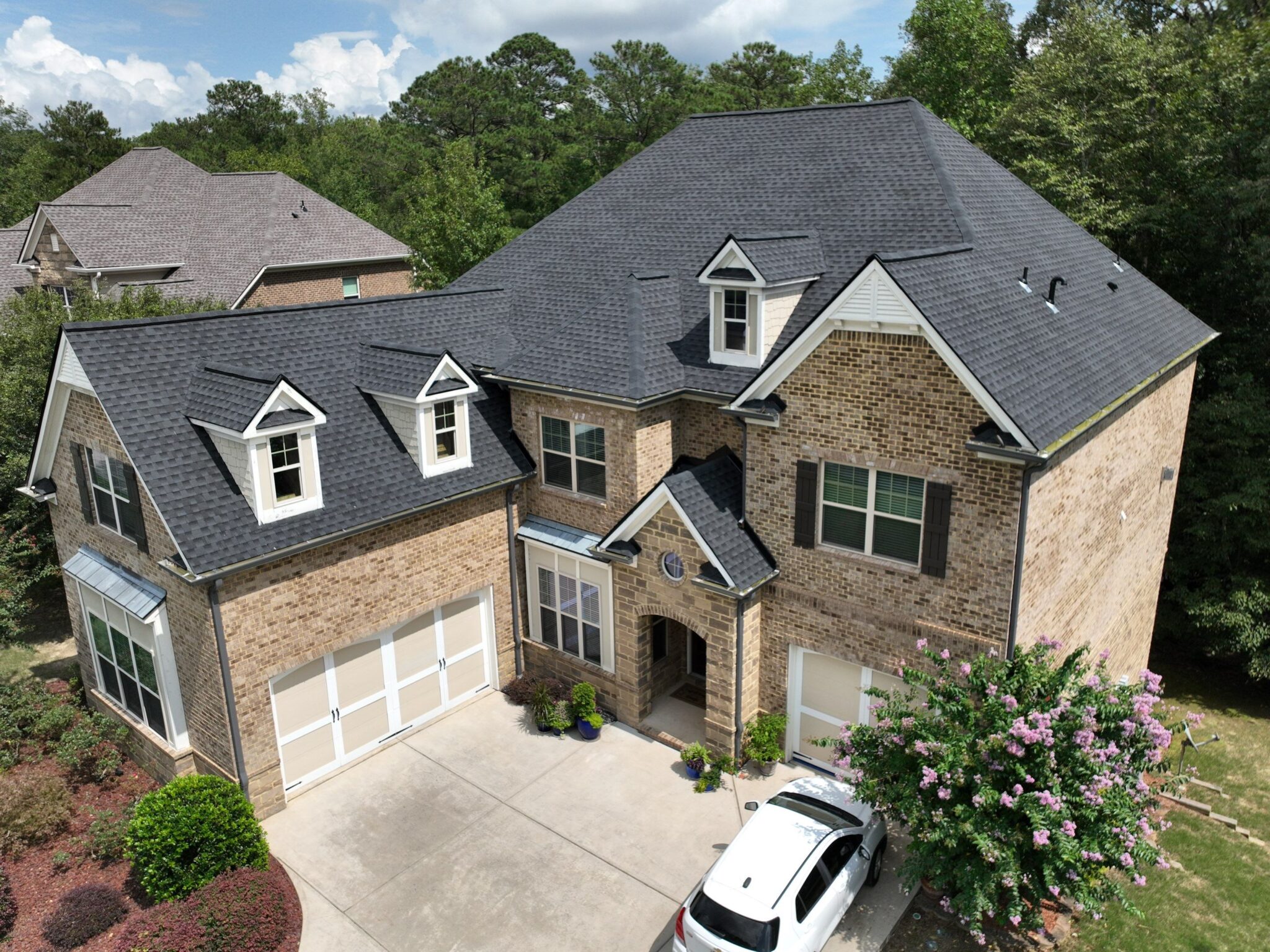 Peachtree Corners, GA Roofing | Dom Roofing & Restoration 3 Charcoal architectural shingle roof installed by Dom Roofing on a large brick home in Peachtree Corners, GA