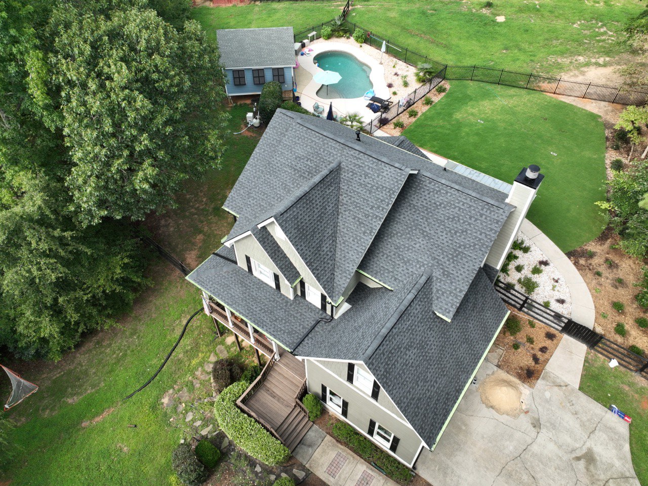 Roofing Company in Vinings, GA 1 Aerial view of a completed shingle roof replacement on a home with pool by Dom Roofing, serving Vinings, GA