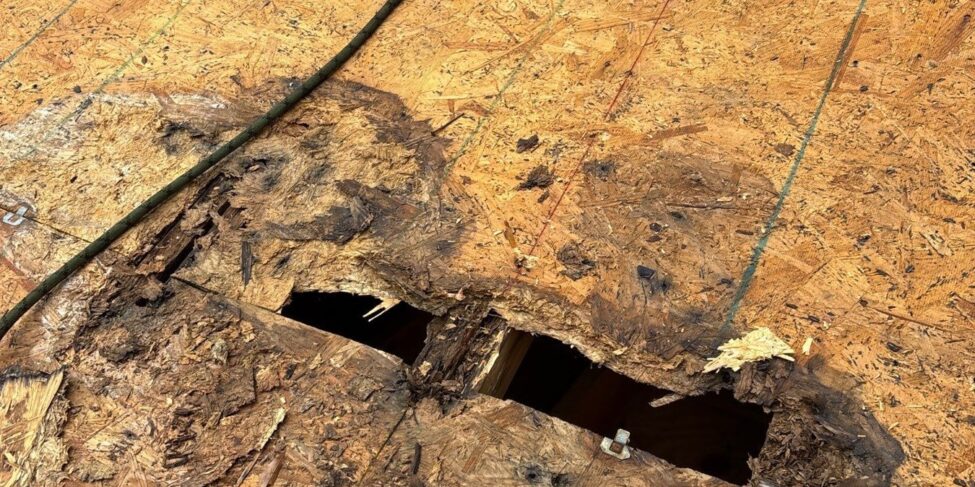 Damaged roof decking exposed during tear-off