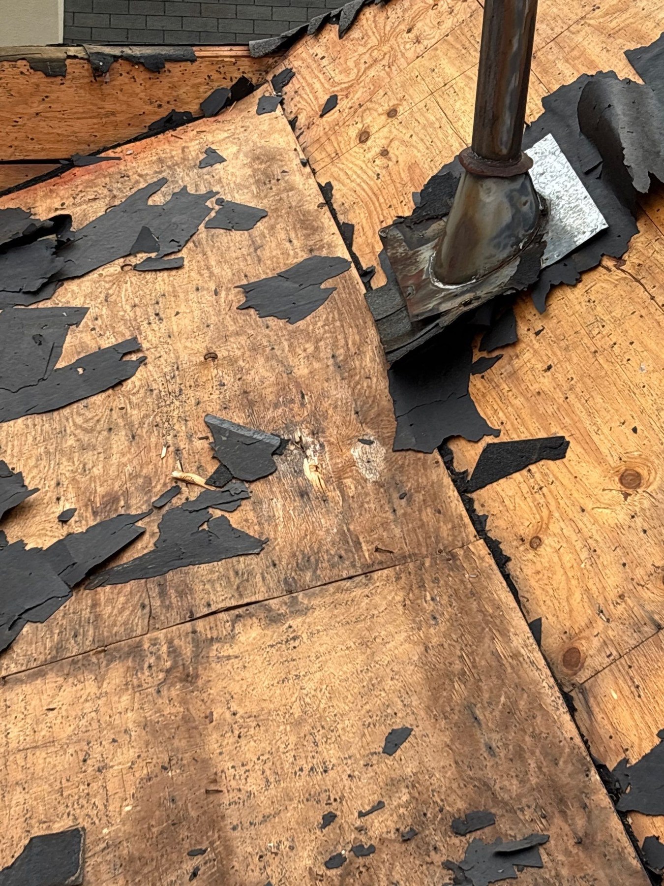 Roof Decking: Signs of Rot & Replacement Cost (2026) 1 Deteriorated wood roof decking around a vent penetration
