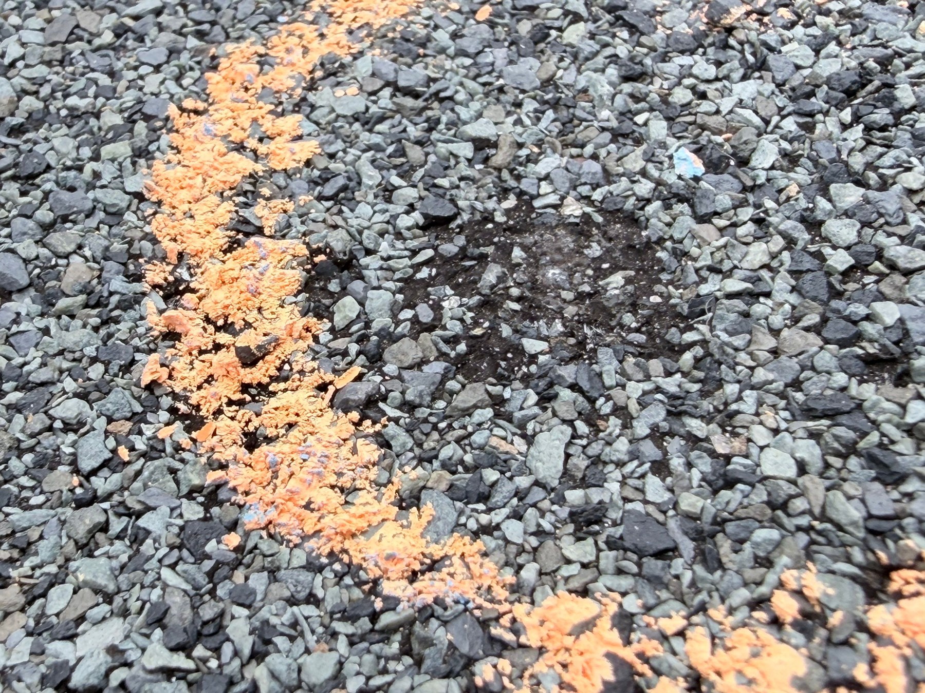What Does Hail Damage Look Like on a Roof? (Photo Guide) 1 Chalk-marked shingle area with localized granule loss