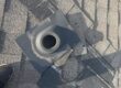 Roof vent pipe and flashing boot surrounded by asphalt shingles