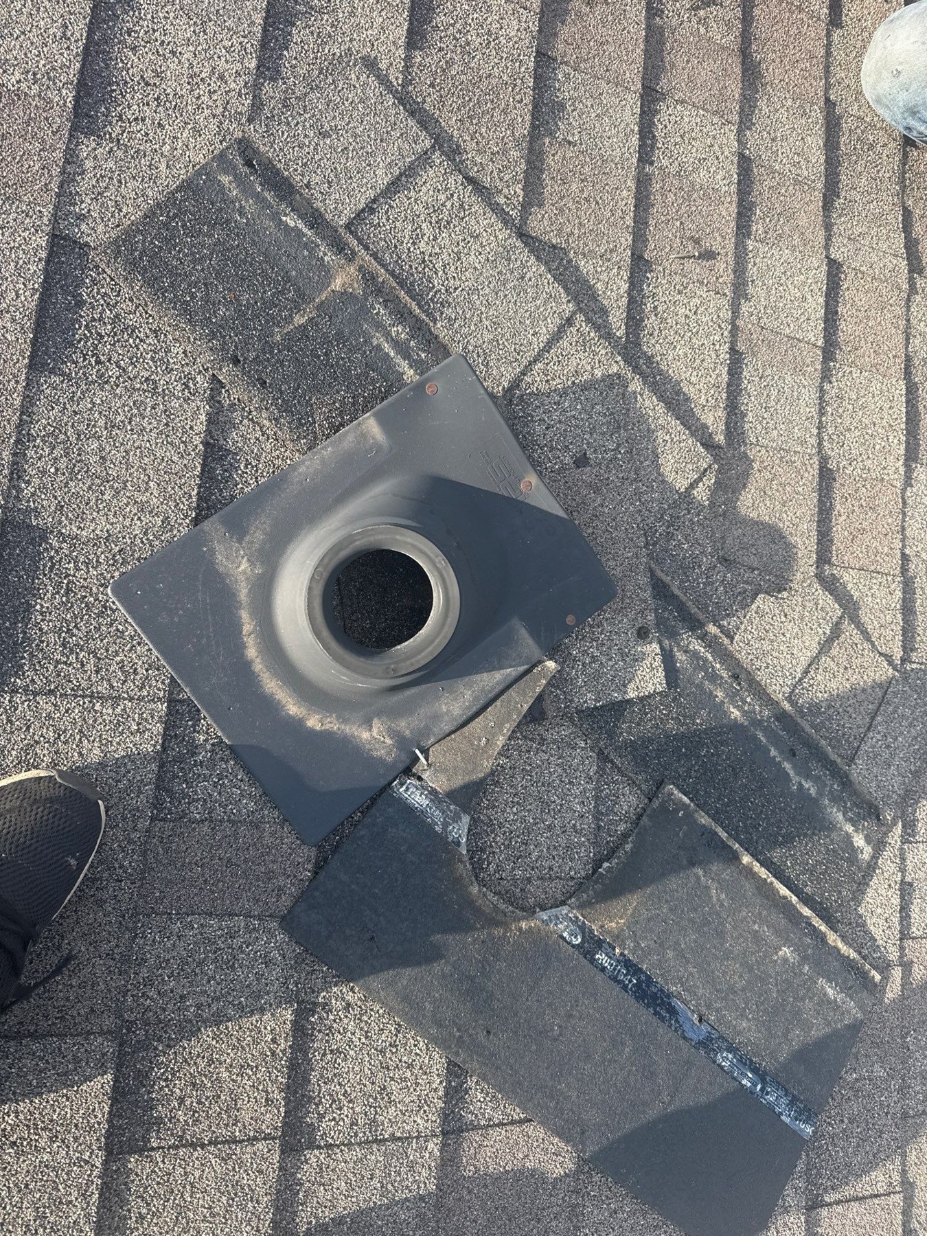 dom-real-leak-01 Roof vent pipe and flashing boot surrounded by asphalt shingles