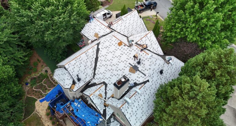 Aerial view of a roof covered with synthetic underlayment during installation