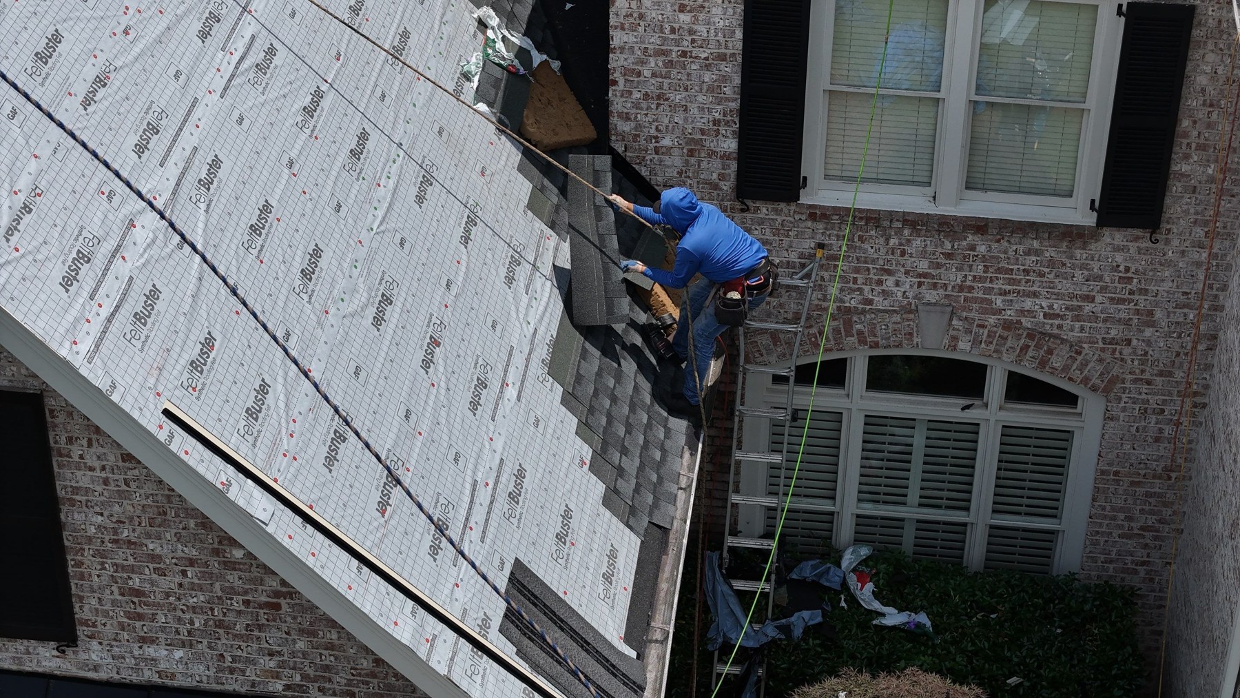 Roof Underlayment: Felt vs. Synthetic for Georgia Homes 2 Roofing crew installing synthetic underlayment on a sloped roof