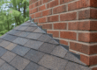 Step flashing and counterflashing at a brick chimney on a Georgia roof