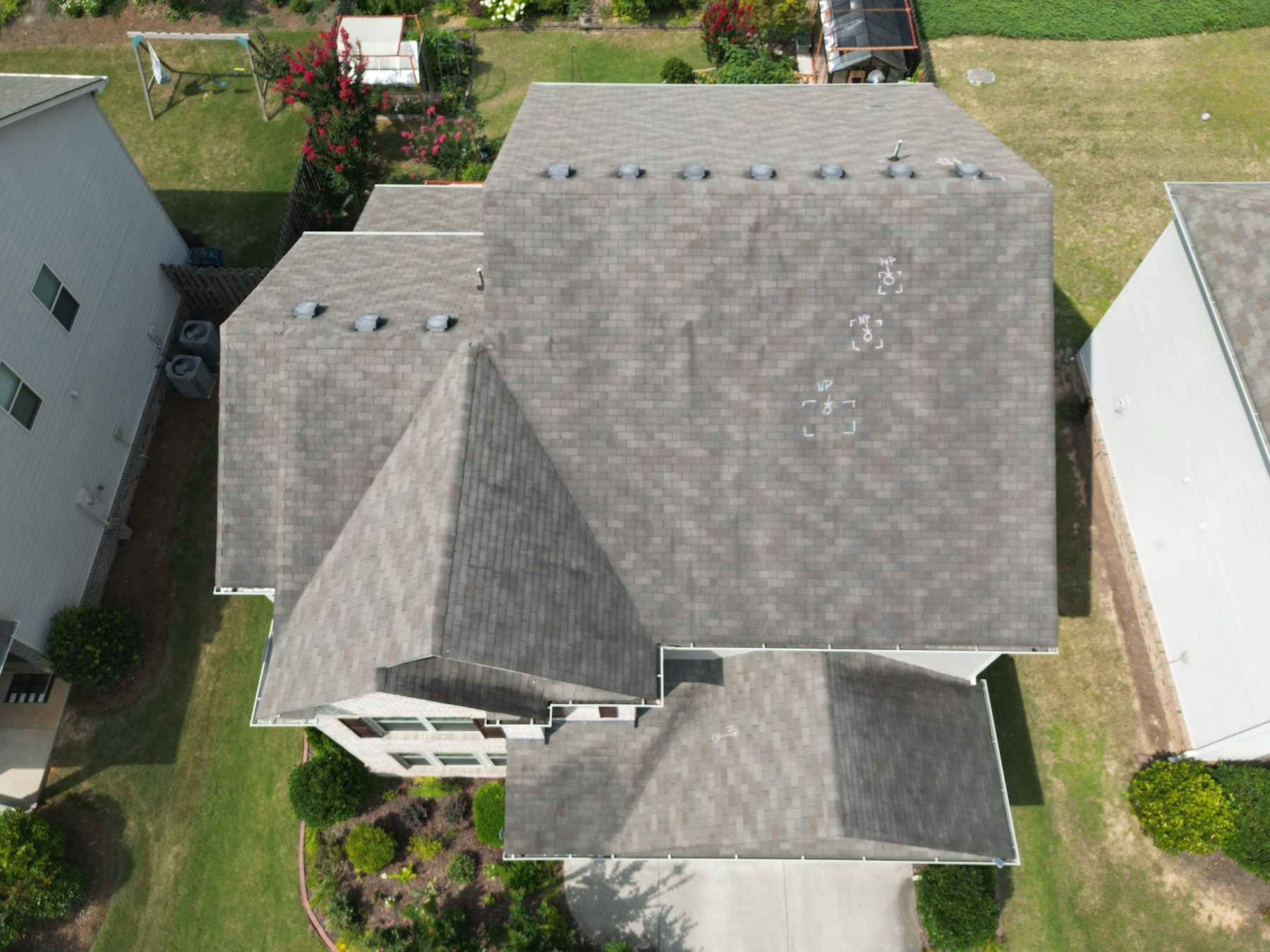 dom-real-weathered-shingle-roof Aerial inspection photo of an asphalt shingle roof with dark streaks and uneven discoloration